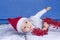 Little funny Santa boy playing with christmas or new year holiday festive garland. 1 year old baby boy in Santa Claus cap