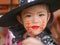 Little girl, 3 years old, is happy with her Halloween makeup and pretend playing as a powerful witch