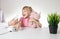 A little girl 5 years old in a pink T-shirt breathes into a nebulizer for lung disease. Treatment of bronchitis with inhalation,