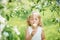 Little girl 5 years old sniffing a dandelion