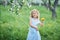 Little girl 5 years old sniffing a dandelion