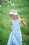 Little girl 5 years old sniffing a dandelion