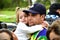 Little girl affectionately hugs her father at the demonstration against the result of the presidential election