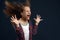 Little girl against powerful airflow in studio