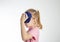 A little girl aged seven holds a cold bag of ice to her head. The concept of applying cold for headaches and cramps