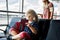 Little girl at the airport waiting for boarding at the big window. Cute kid holding passport..Looking forward to leaving