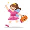 Little girl in Angel costume with pumpkin basket for Trick or Treat.