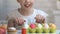 Little girl appearing from under table like rabbit to enjoy brightly dyed eggs