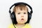 Little girl attentively listening with headphones