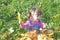 Little girl with autumn leaves