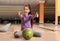 Little girl with ball in bowling