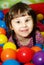 Little girl in ball pool.