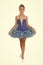 Little girl in ballet position. Little ballerina in blue tutu. Adorable ballerina girl take dance lesson. Dancing queen