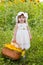 Little girl with a basket with sunflowers