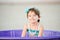 Little Girl In bathing Suit in Plastic Pool