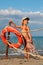 Little girl in bathing suit standing on beach