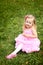 Little girl in a beautiful dress in a summer park