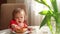 A little girl in a beautiful dress takes small pieces of baked chicken and puts it in her mouth. Baby toddler eating chicken meat