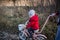 A little girl on a bicycle rides on a dirt dirt road. Ukrainian child immigrant