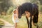 Little girl with black friesian stallion