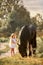 Little girl with black friesian stallion