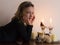 Little girl in black lying down with face in her hands next to lighted candles