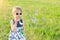 Little girl blowing bubbles in the park, free space.