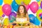 Little girl blowing candles on birthday cake