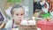 Little girl blowing candles on birthday cake