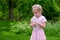 Little girl blowing dandelion fluff