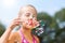 Little girl blowing soap bubble outdoor