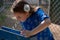 Little Girl in Blue Dress Using Drinking Fountain