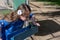 Little Girl in Blue Dress Using Drinking Fountain