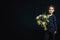 Little girl with bouquet of flowers in her hand. The concept of happiness, people, child, childhood. Studio photo on a black backg