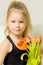 Little girl with a bouquet of tulips.