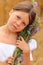 Little girl with a bouquet of wildflowers in her hands in a wheat field.