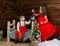 A little girl and a boy look at the Christmas candle. Wooden background. Preparing for the New Year and Christmas. A