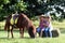 Little girl and boy with pony horse