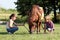 Little girl and boy with pony horse