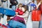 Little girl and boy sitting on suitcases on airport