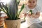 Little girl breaking houseplant at home