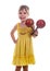 Little girl in a bright yellow dress holding maracas in her hands. Studio photo, bright white background.