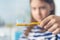 Little girl brushing teeth. Close-up photo. striped toothpaste on a toothbrush on a blurred background of child.