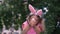 Little Girl in Bunny Ears Plays with Cute Chick
