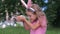 Little Girl in Bunny Ears Plays with Cute Chicken