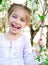 Little girl with bush blossoming