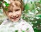 Little girl with bush blossoming tree