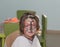 little girl with butterfly painted face sitting inside the room