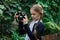 Little girl with camera in hands outdoors