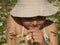 Little girl with a camomile in her hand in the middle of the chamomile field